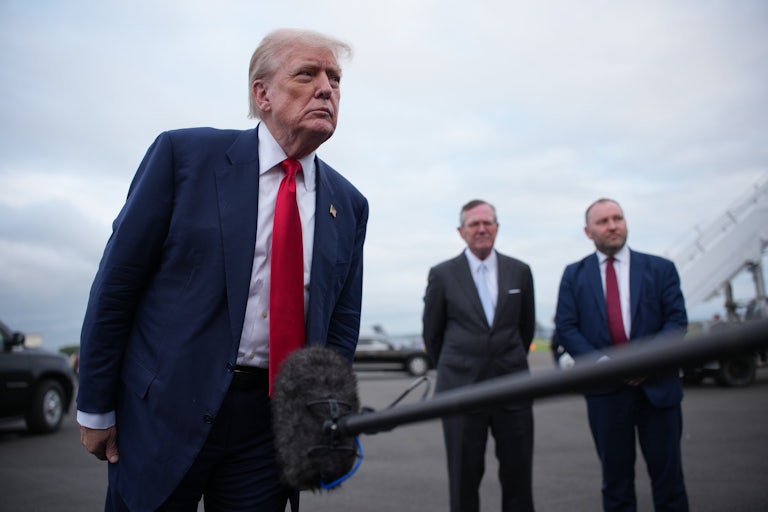 Donald Trump speaks to reporters, as Ian Murray, M.P., Secretary of State for Scotland, and Warren Stephens, U.S. Ambassador to the United Kingdom stand in the background.