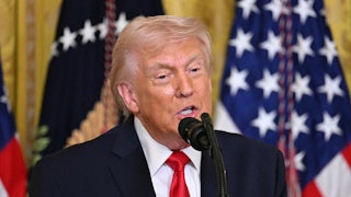 President Donald Trump speaking into a mic