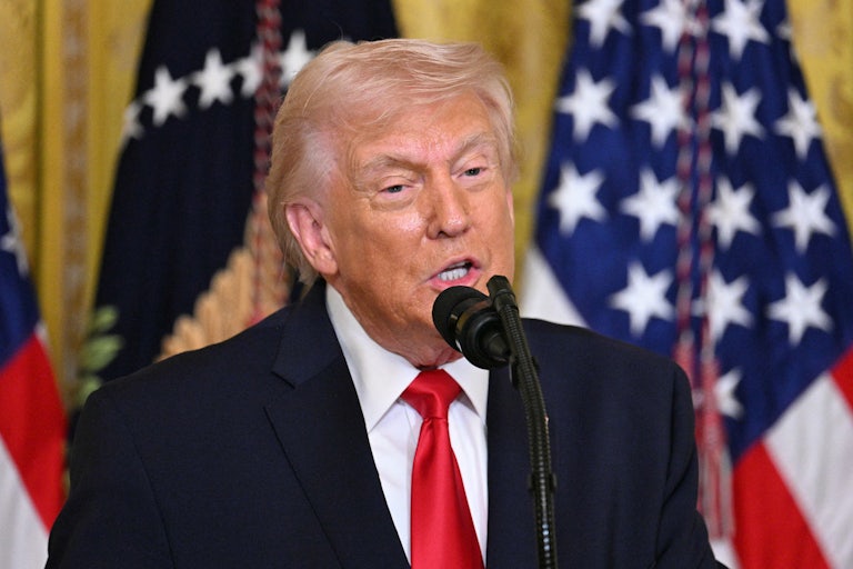 President Donald Trump speaking into a mic