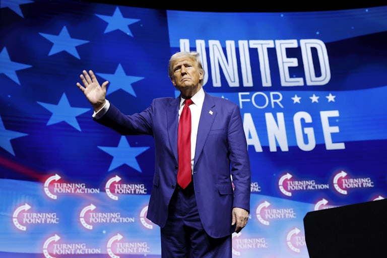 Donald Trump waves while on stage at a campaign event