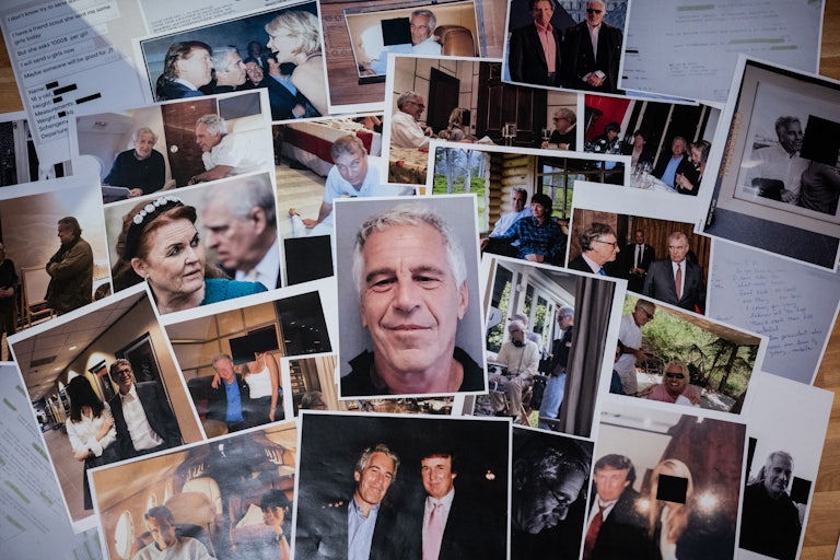Photos of Jeffrey Epstien and his friends and acquaintances spread across a table.