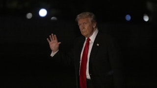 Donald Trump waves while walking outside the White House