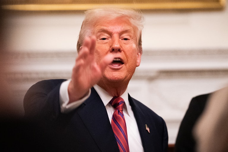 Donald Trump gestures while speaking at a dinner at the White House