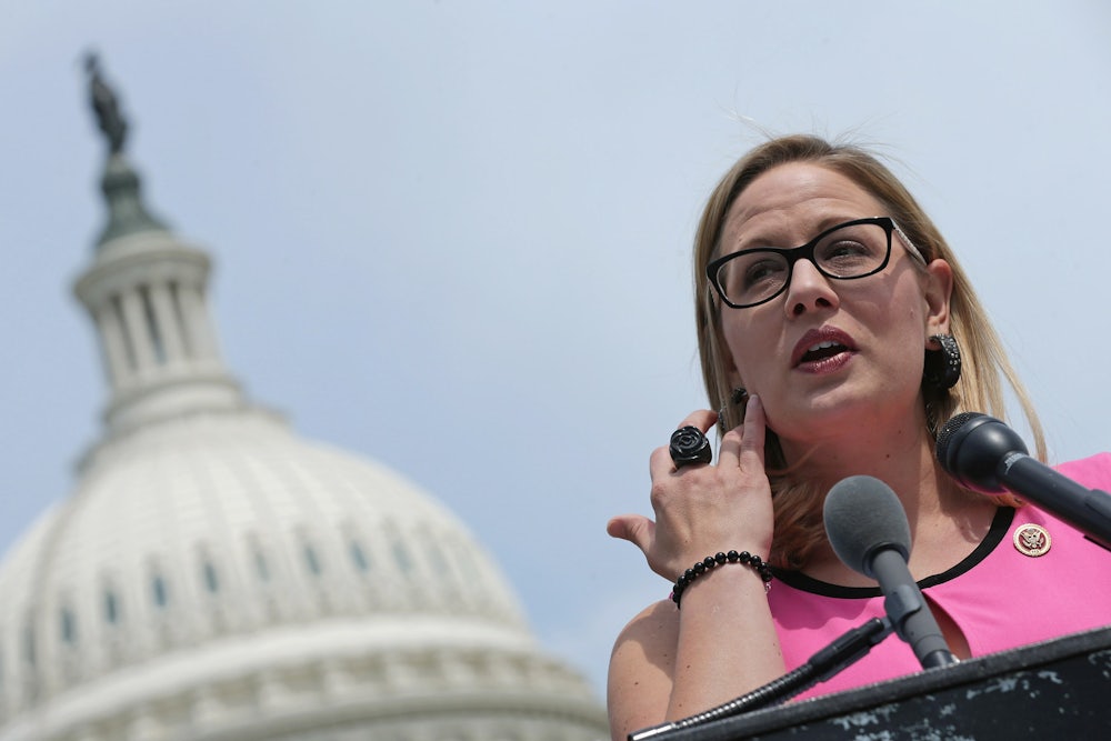Arizona Senator Kyrsten Sinema stands outside the U.S. Capitol.