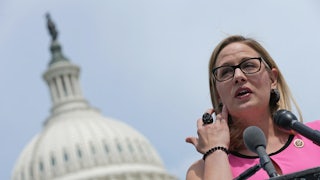Arizona Senator Kyrsten Sinema stands outside the U.S. Capitol.