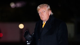 Donald Trump waves while walking outside the White House