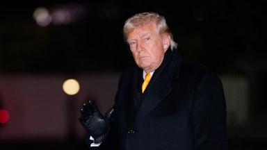 Donald Trump waves while walking outside the White House