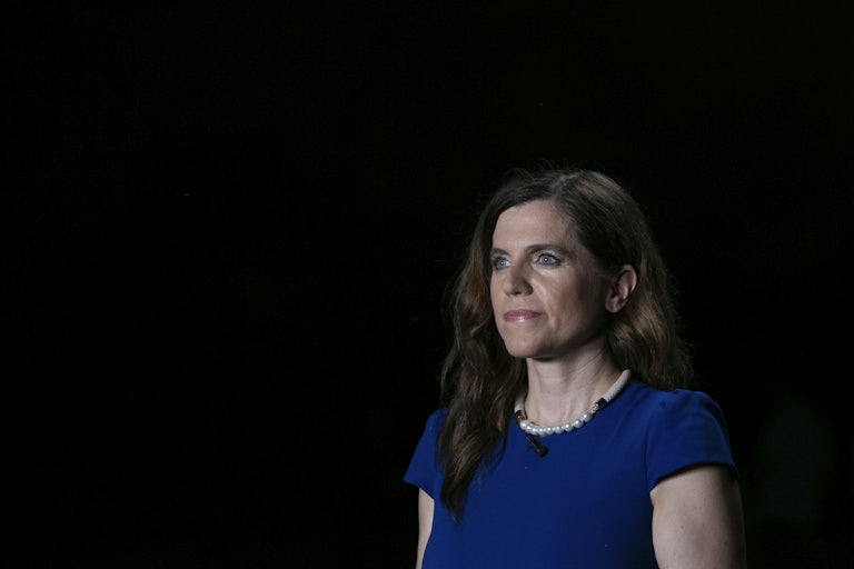 Nancy Mace stares into space in front of a black background
