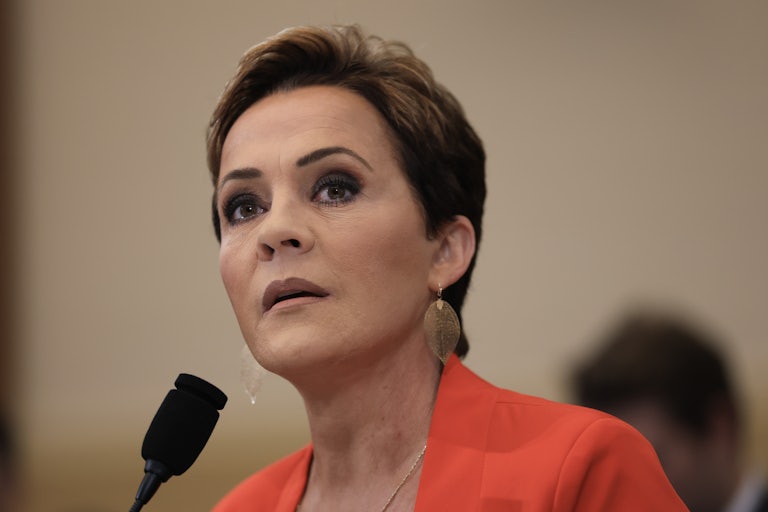 Kari Lake sits in front of a microphone in a House committee hearing