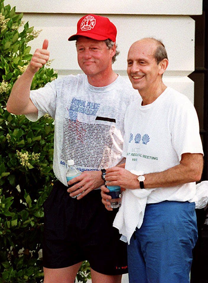US President Bill Clinton (L) responds, in Washington, DC 16 May 1994, to reporters who asked if Judge Stephen Breyer (R) will be confirmed as the next US Supreme Court Judge. Judge Breyer joined the President for an early morning jog on the Mall. 