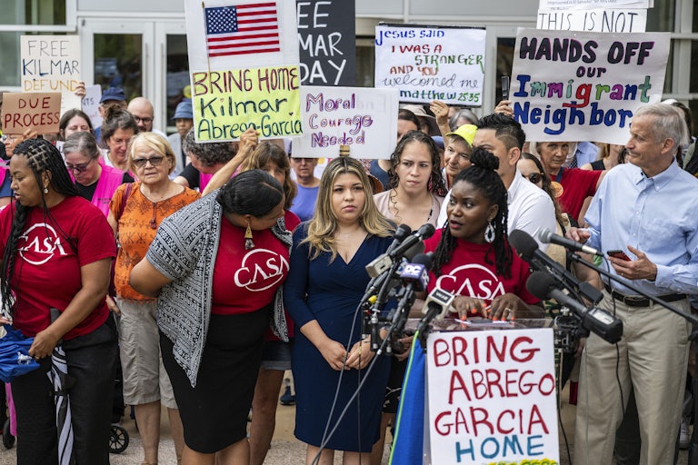 Kilmar Abrego Garcia's wife stands in the center of a crowd of people protesting in his support outside a courthouse in Greenbelt, Maryland