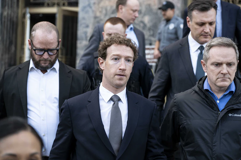 Meta CEO Mark Zuckerberg looks worried as he leaves court alongside other men.