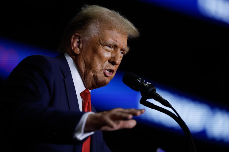 Donald Trump speaking at a mic