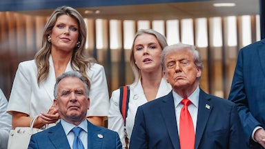 Lindsey Halligan and Karoline Leavitt stand next to each other, while Steve Witkoff and Donald Trump stand in front of them.