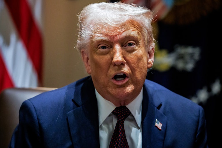 Donald Trump speaks while sitting in a Cabinet meeting at the White House