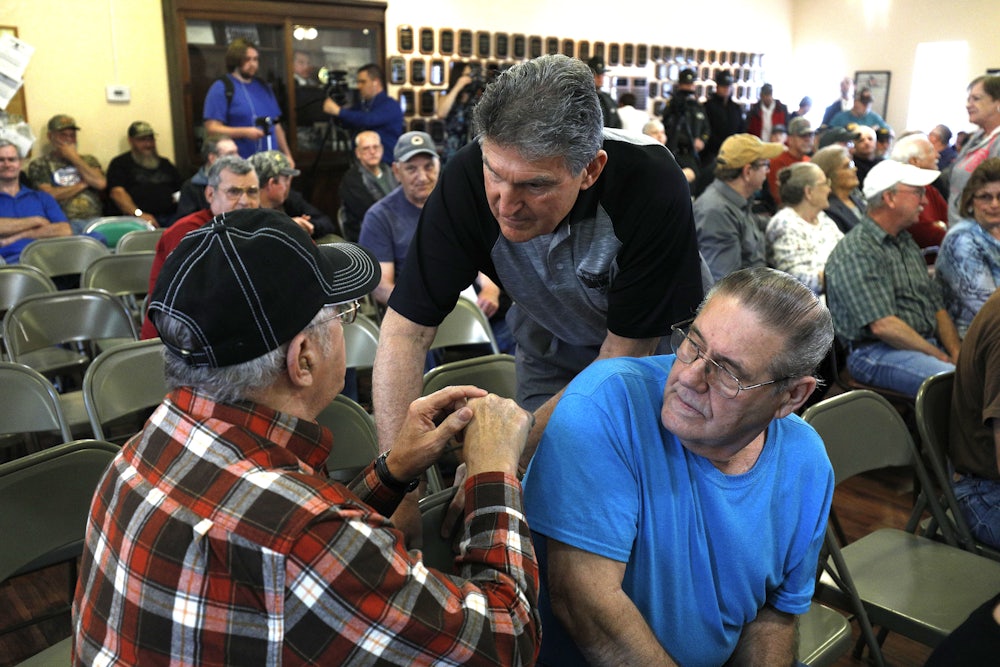 Manchin shakes hands with coal miners