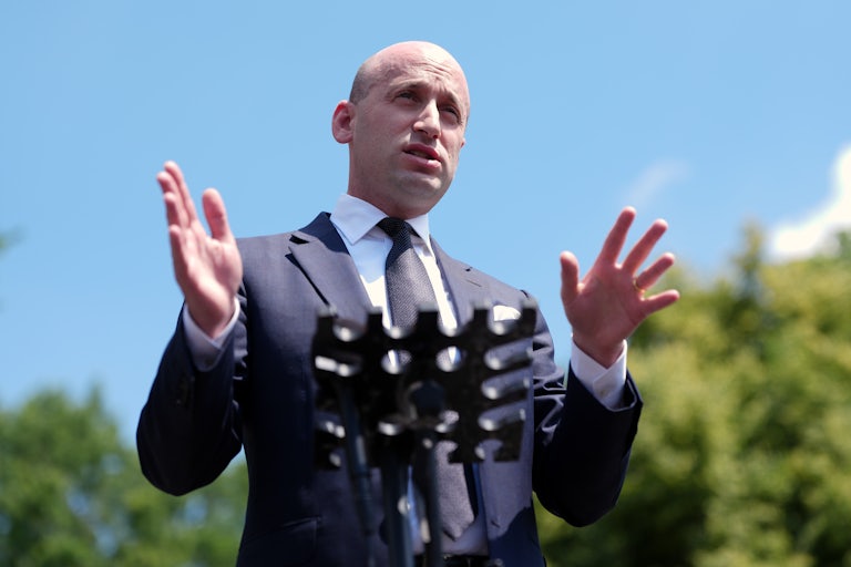 Stephen Miller gestures while speaking to reporters outside the White House