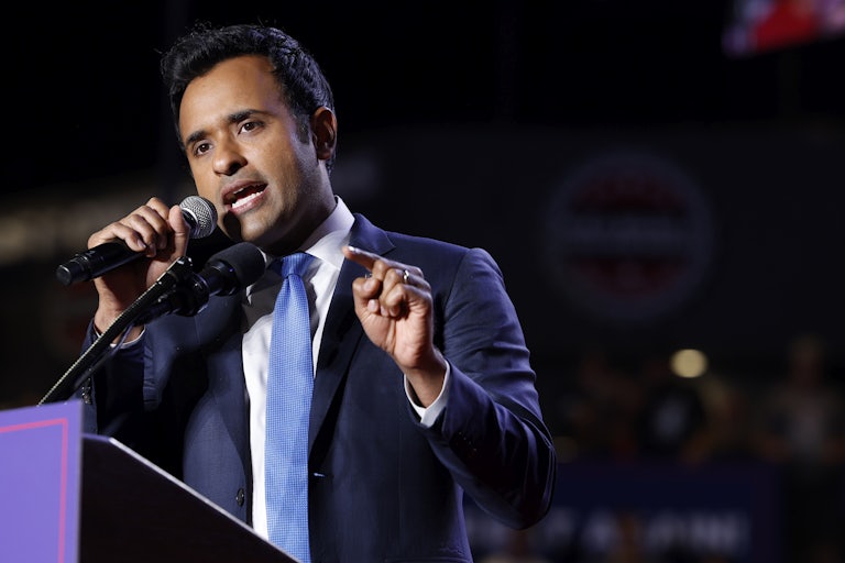 Vivek Ramaswamy gestures while speaking at a podium during a Donald Trump rally