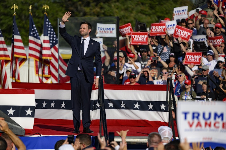 JD Vance waves to a large crowd at a Donald Trump campaign rally