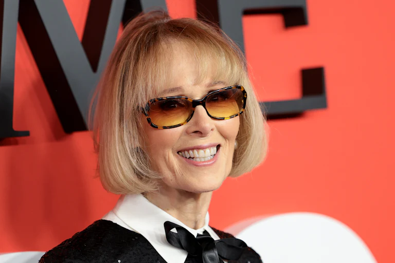 E. Jean Carroll smiles in front of a TIME backdrop.