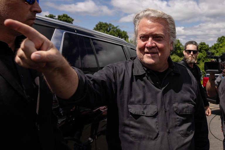 Steve Bannon points at supporters before going to jail