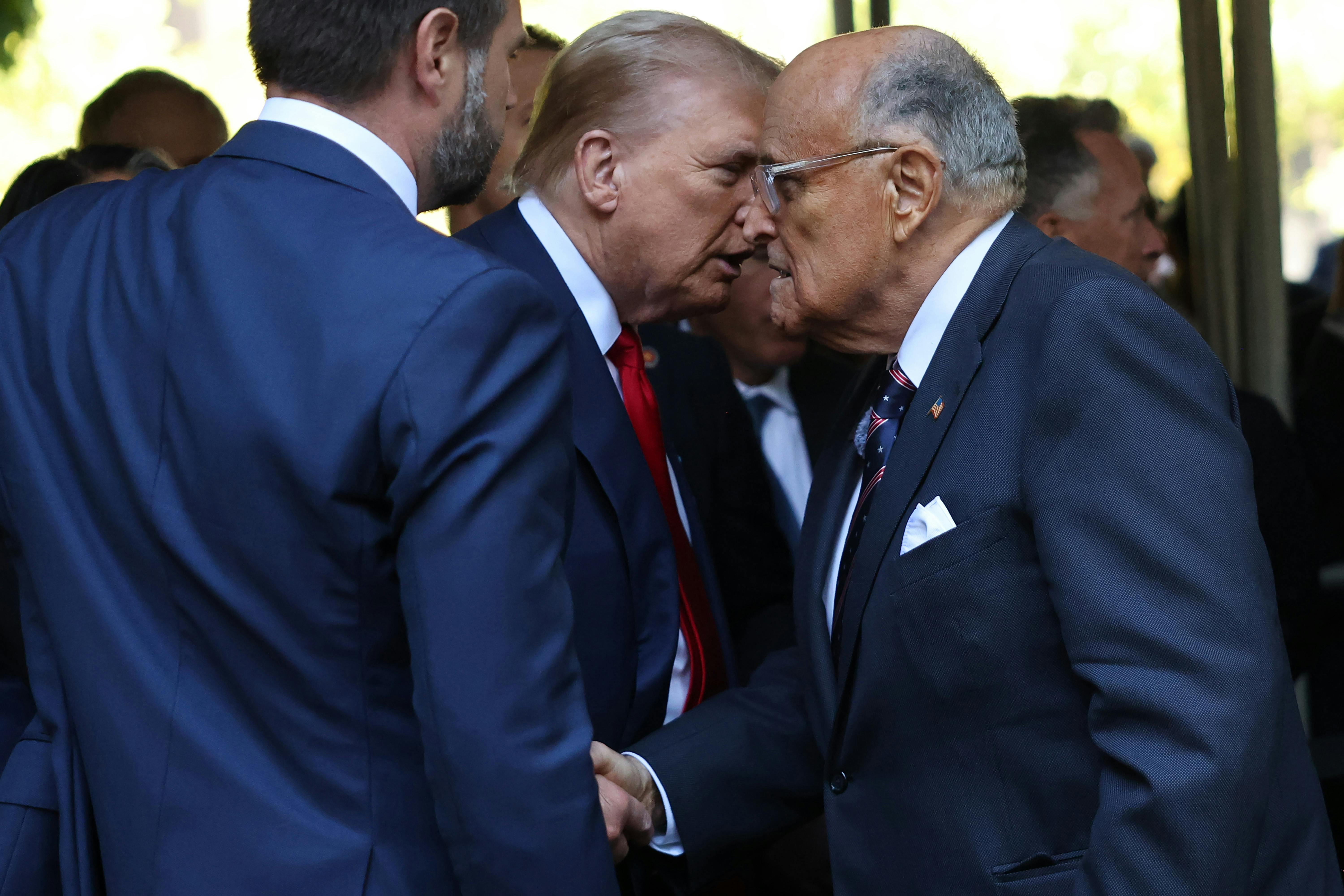 Donald Trump shakes hands with Rudy Giuliani