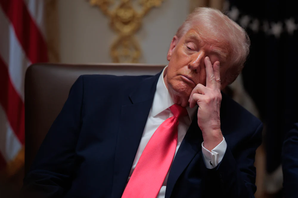 Donald Trump puts fingers to his left eye while dozing off