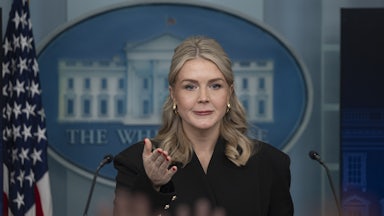 Press Secretary Karoline Leavitt gestures while standing at the podium in the White House press briefing room