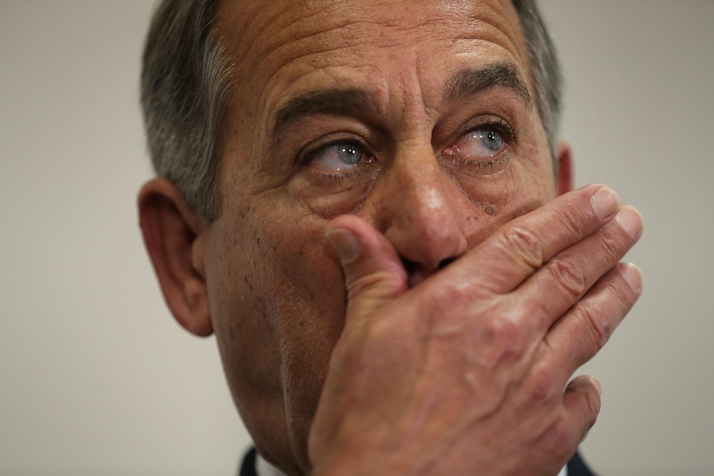 John Boehner covers his mouth while listening to a news briefing.