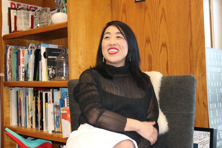 Philadelphia mayoral candidate Helen Gym seated with a bookcase behind her