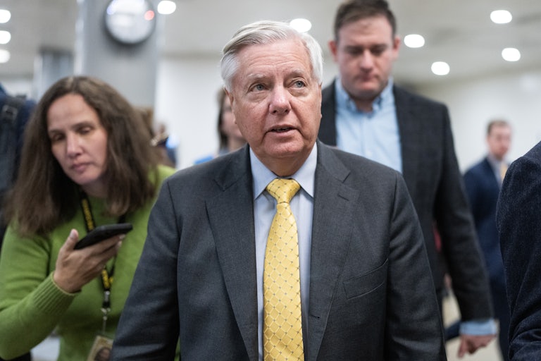 Lindsey Graham walks past reporters