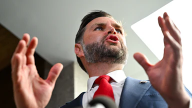 Vice President JD Vance gestures while speaking to reporters