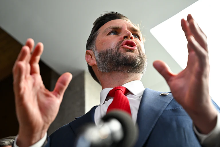 Vice President JD Vance gestures while speaking to reporters