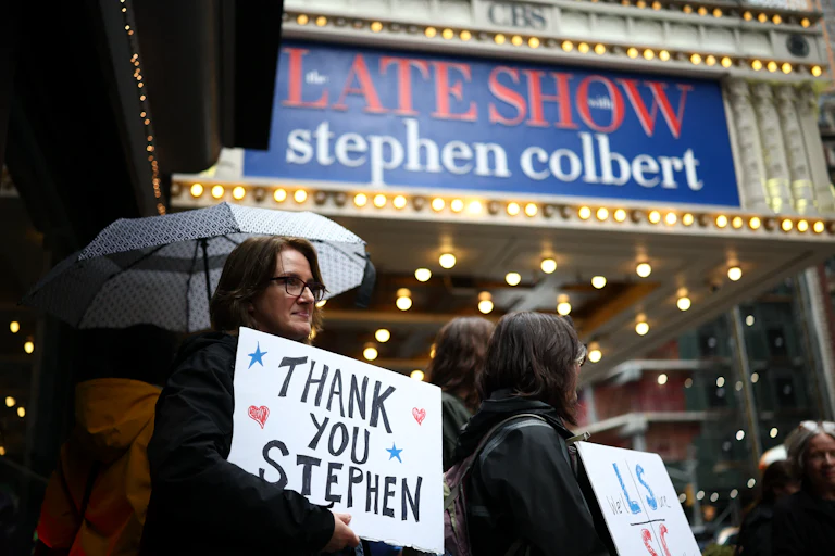 A person holds a sign that says "Thank you Stephen" while standing outside the studio for "The Late Show With Stephen Colbert"