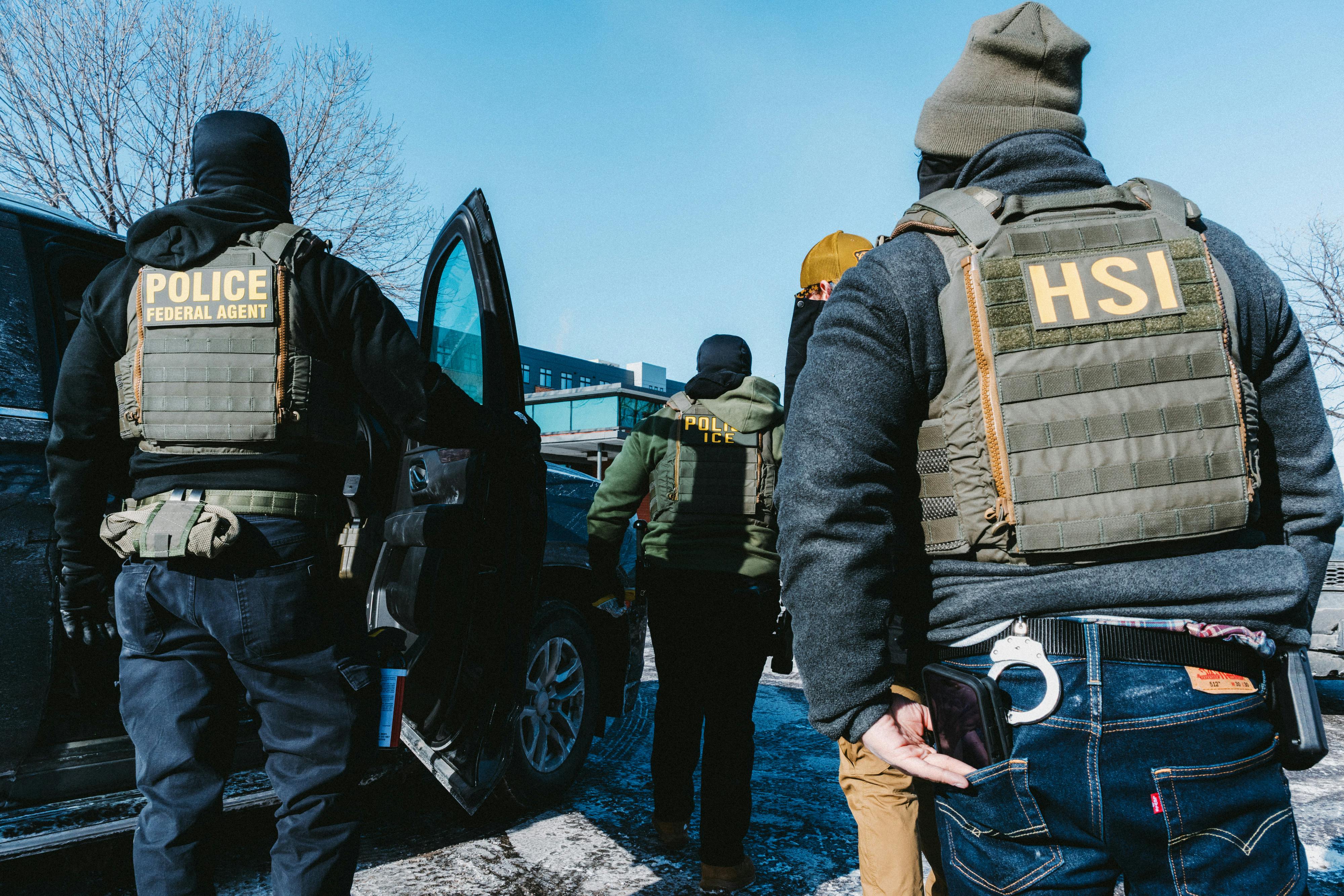 Federal immigration agents stand in a parking lot in Minneapolis, Minnesota