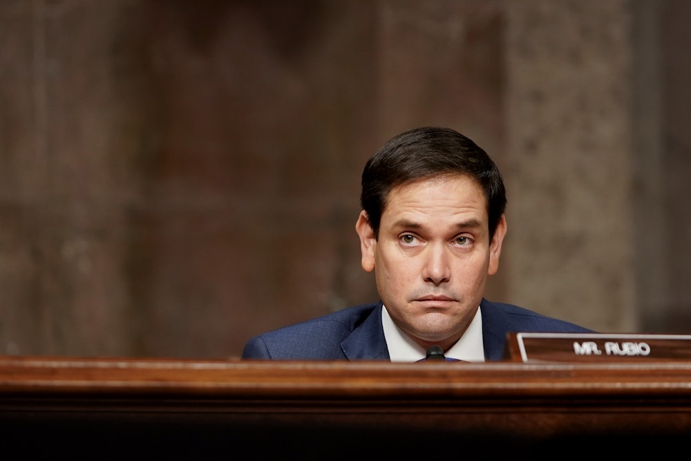 Republican Senator Marco Rubio sits behind his name plate.
