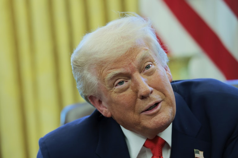 Donald Trump speaks to reporters while in the Oval Office of the White House.