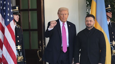Donald Trump raises his fist while standing next to Ukrainian President Volodymyr Zelenskiy in front of the White House