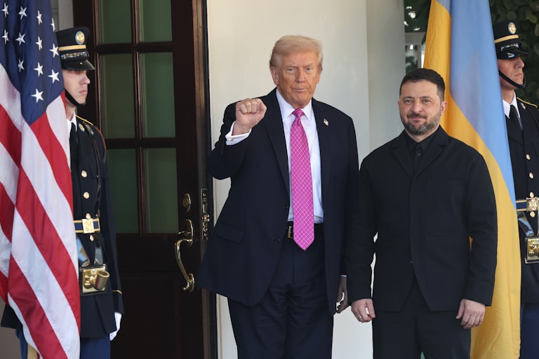 Donald Trump raises his fist while standing next to Ukrainian President Volodymyr Zelenskiy in front of the White House