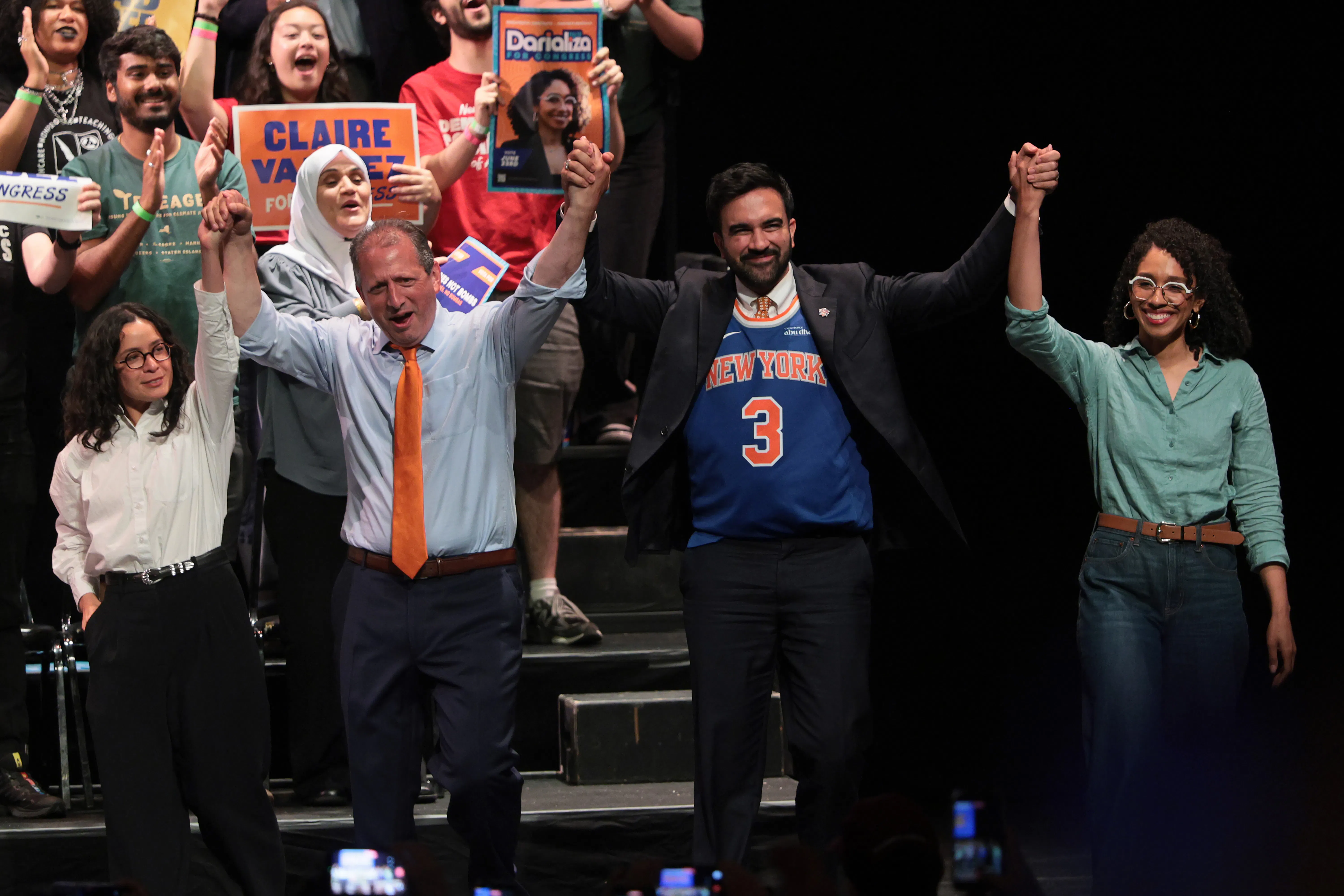 Congressional candidate Claire Valdez, Congressional candidate Brad Lander, Mayor Zohran Mamdani, and Congressional candidate Darializa Avila Chevalier raise their hands during a Get Out the Vote rally.