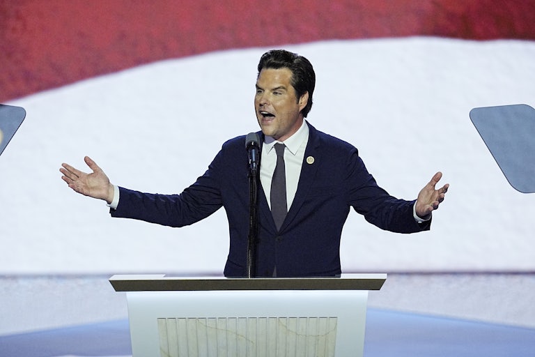 Matt Gaetz holds his arms out while speaking at a podium during the Republican National Convention