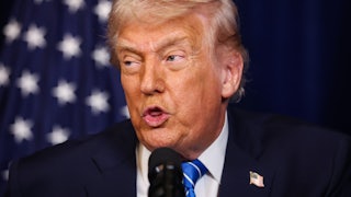 Donald Trump speaks into a microphone during a joint press conference with Ukrainian President Volodymyr Zelenskiy