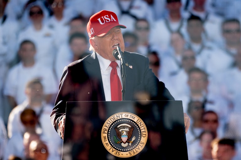 Donald Trump speaks at a podium during an event for the Navy's 250th anniversary