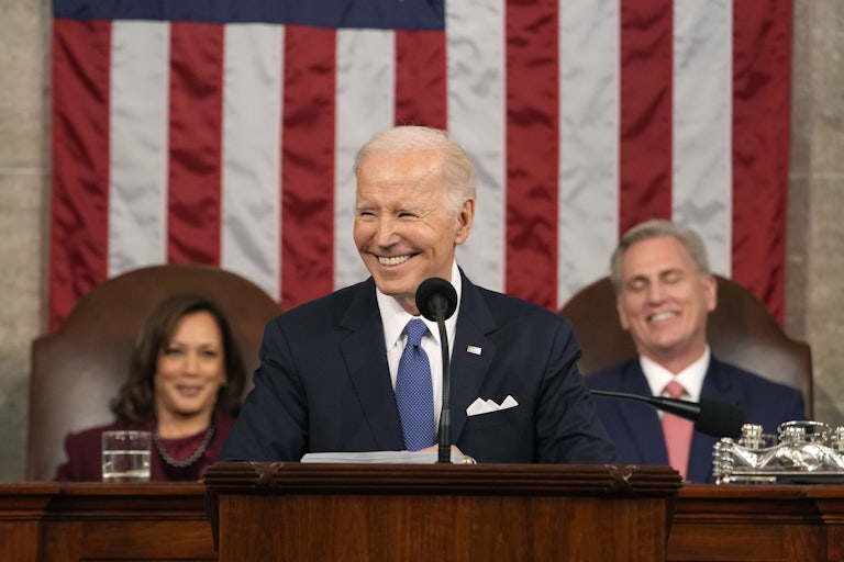 Joe Biden smiles at the podium during his State of the Union speech