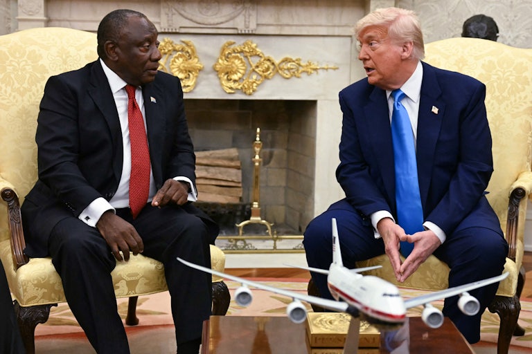 South African President Cyril Ramaphosa and Donald Trump sit next to each other and speak in the Oval Office