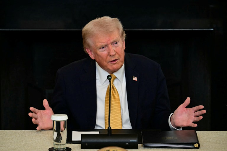 Donald Trump gestures while speaking during an event