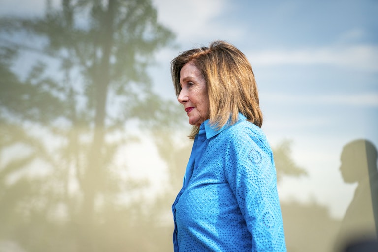 Nancy Pelosi walks outside the Democratic Congressional Campaign Committee office