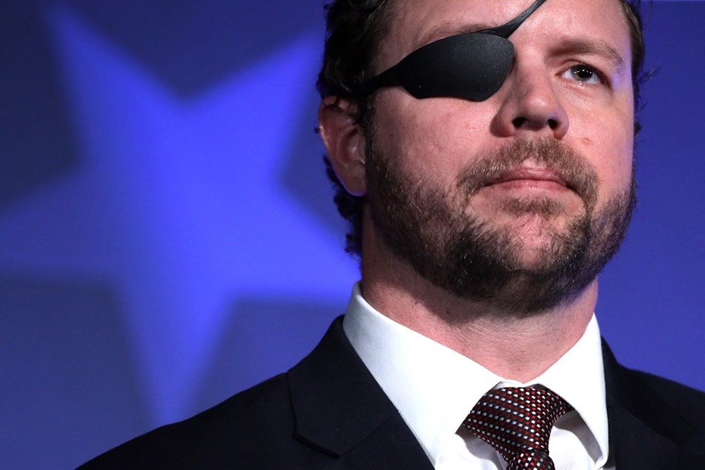 Texas Representative Dan Crenshaw stands against a blue backdrop