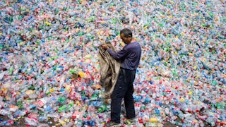 A Chinese laborer sorts plastic bottles