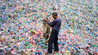 A Chinese laborer sorts plastic bottles